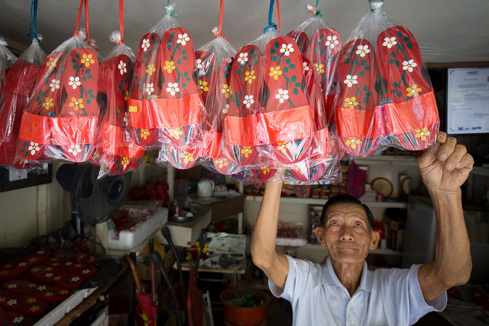 Cheah Bak Chong arranging the handmade clogs at his shop in Jalan Silang, Ipoh. u00e2u20acu201d Picture by Marcus Pheong