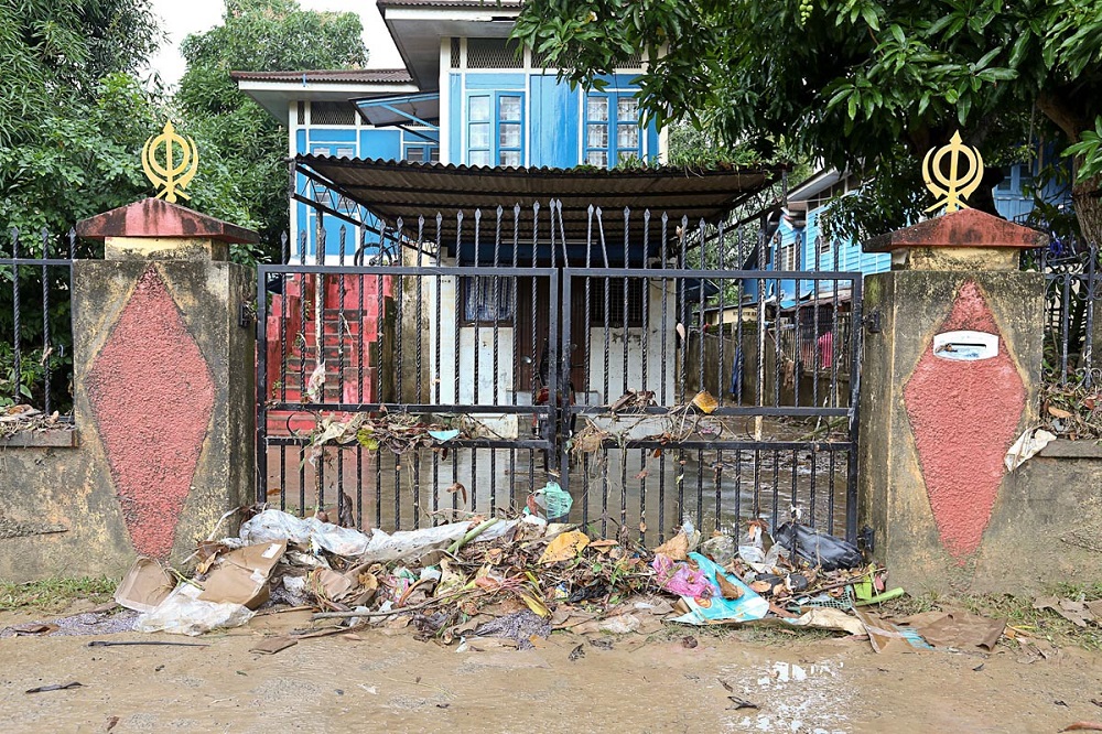 Garbage is seen piled outside the gate of a house along Jalan P. Ramlee after a flash flood in George Town July 30, 2018.
