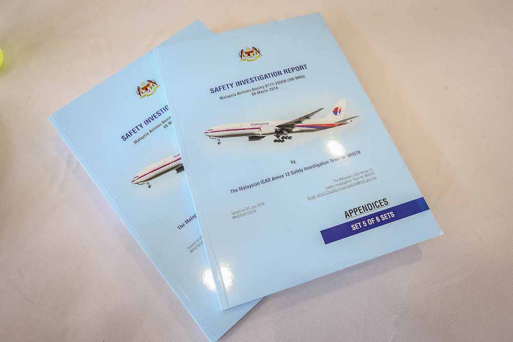 Copies of the MH370 briefing report are seen at the press conference in Putrajaya July 30, 2018. — Picture by Firdaus Latif