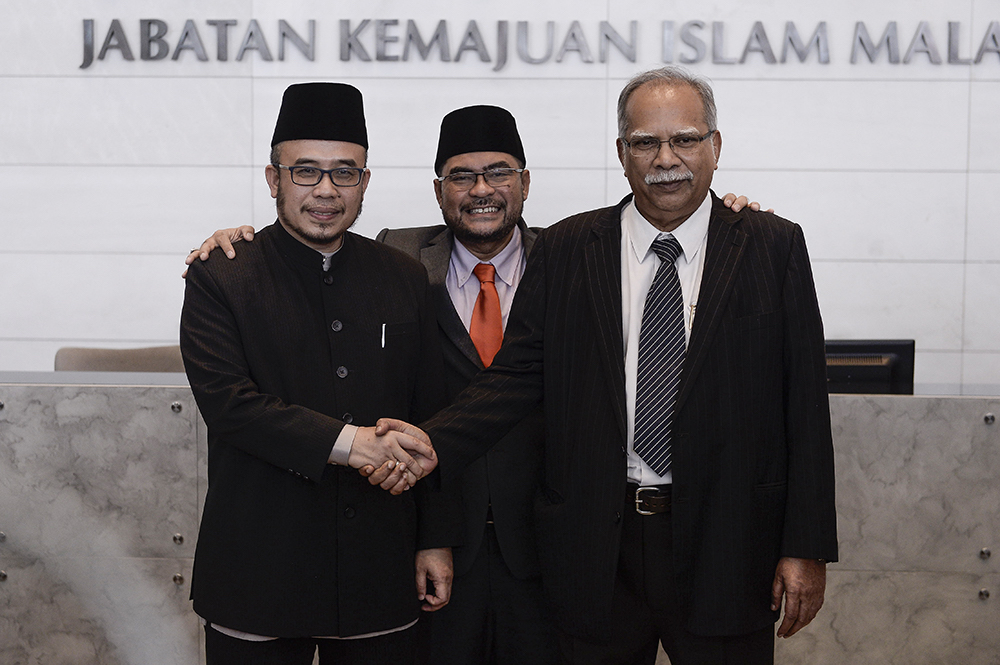 (from left ) Perlis Mufti Datuk Mohd Asri Zainul Abidin, Minister of Religious Affairs, Datuk Mujahid Yusof and Deputy Chief Minister of Penang, P. Ramasamy in Putrajaya July 30, 2018. u00e2u20acu201d Picture by Miera Zulyana