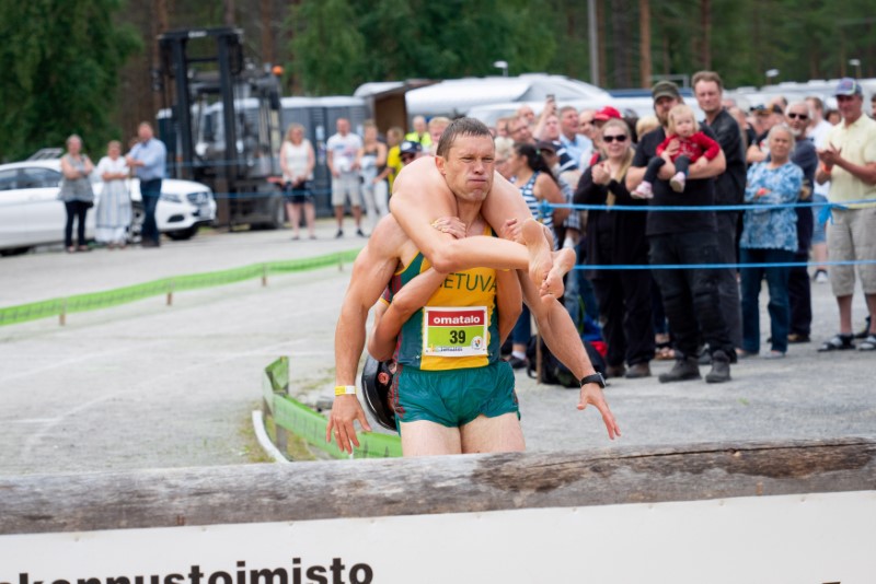 Vytautas Kirkliauskas of Lithuania carries his wife Neringa Kirkliauskiene as they compete during the Wife Carrying World Championships 2018 in Sonkajarvi, Finland, July 7, 2018. u00e2u20acu201d Reuters pic