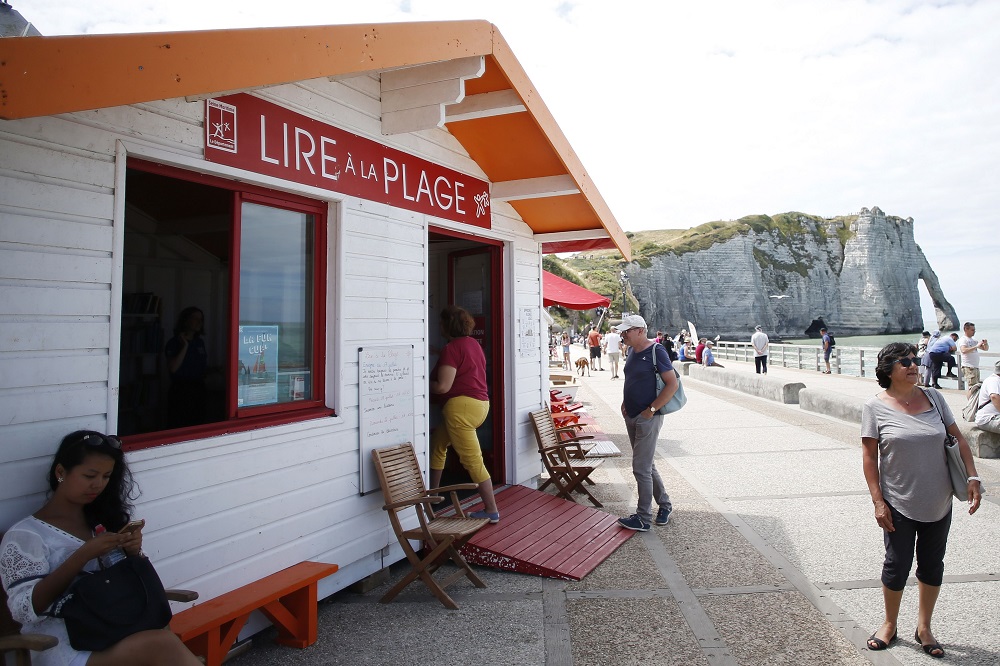 People enter in a little library, open during the summer in Etretat, northwestern France July 16, 2018. u00e2u20acu201d AFP pic