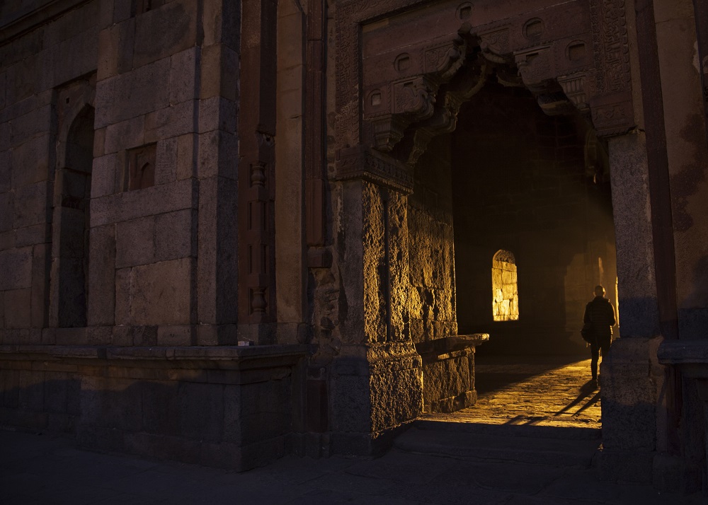 This picture shows an Indian tourist walking inside the ruins of Lodi Gardens at dusk in New Delhi December 7, 2017. u00e2u20acu201d AFP pic