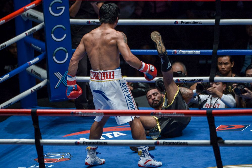 Manny Pacquiao knocks down Lucas Matthysse at the Axiata Arena, Kuala Lumpur July 15, 2018. u00e2u20acu201d Picture by Mukhriz Hazim