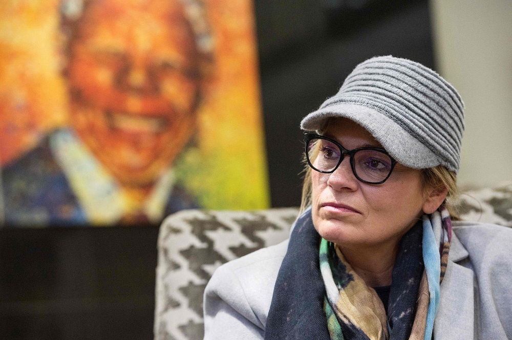 Zelda la Grange, former private secretary to former South African president, and Nobel Prize winner Nelson Mandela (pictured on a painting behind) is pictured during an interview with AFP in Cape Town June 12, 2018. u00e2u20acu201d AFP pic