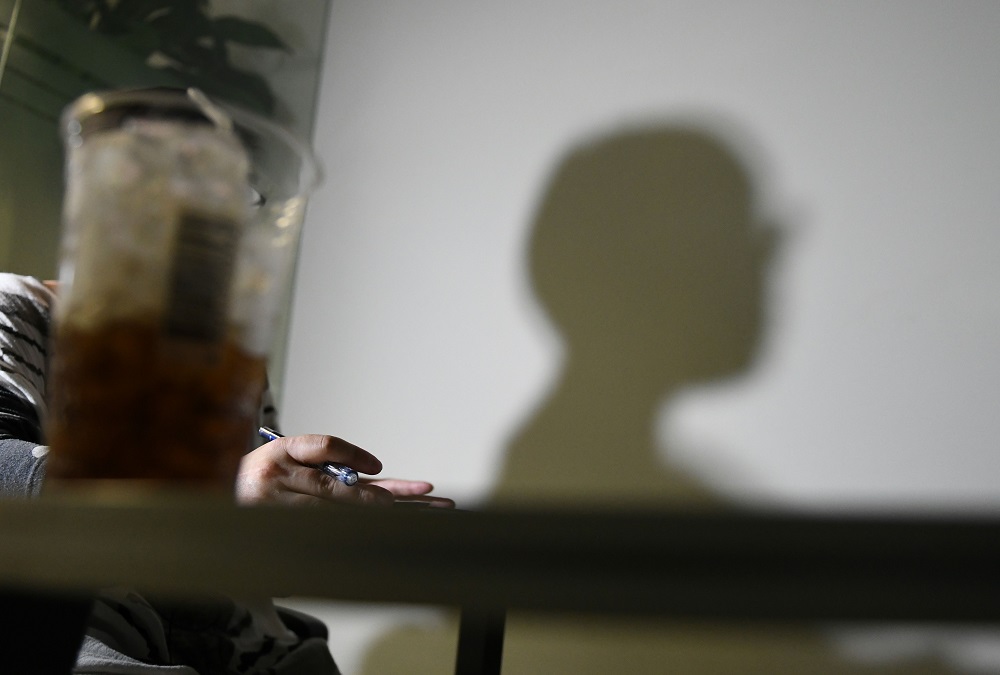 This picture taken on May 31, 2018 shows the shadow of a South Korean woman who asked to be identified only as u00e2u20acu02dcDu00e2u20acu2122 for fear of her personal safety, during an interview with AFP in Seoul. u00e2u20acu201d AFP pic