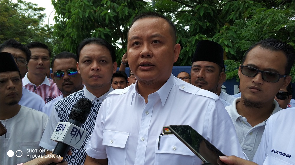 Selangor Umno Youth chief Rizam Ismail, surrounded by his supporters, speaks to reporters before filing a complaint at the Selangor police headquarters in Shah Alam July 30, 2018. u00e2u20acu201d Picture by Yiswaree Palansamy