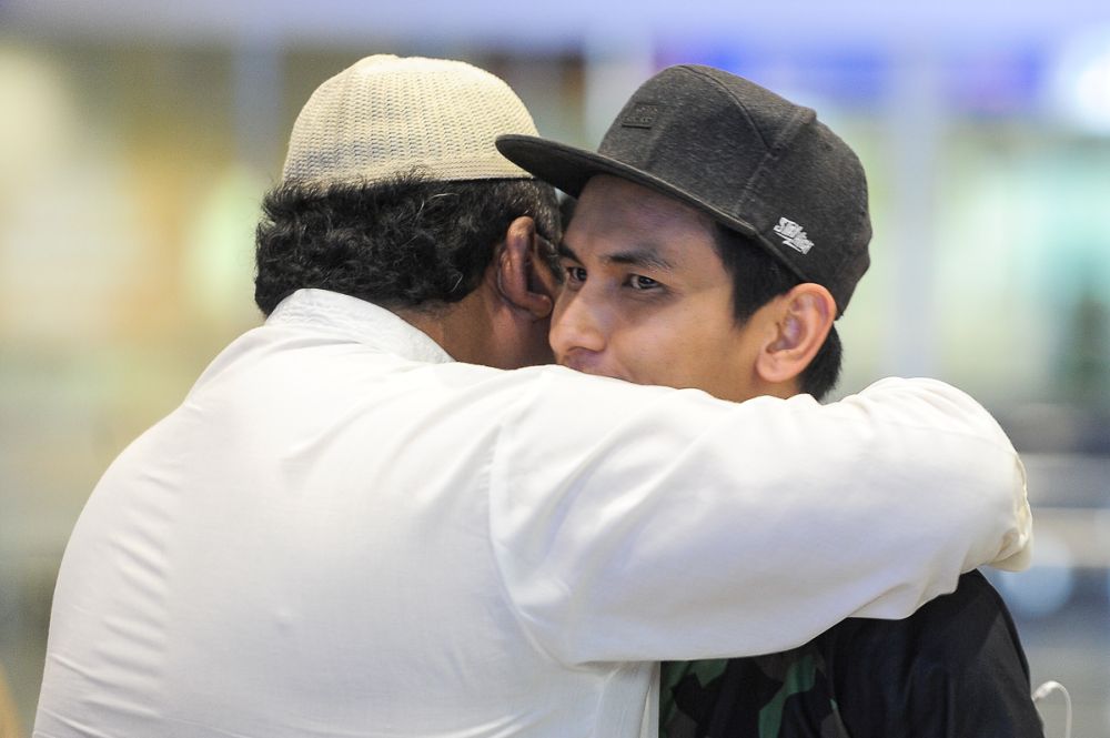Hafiz (right) hugs his cousin after arriving at KLIA from Indonesia July 31, 2018. ― Picture by Shafwan Zaidon