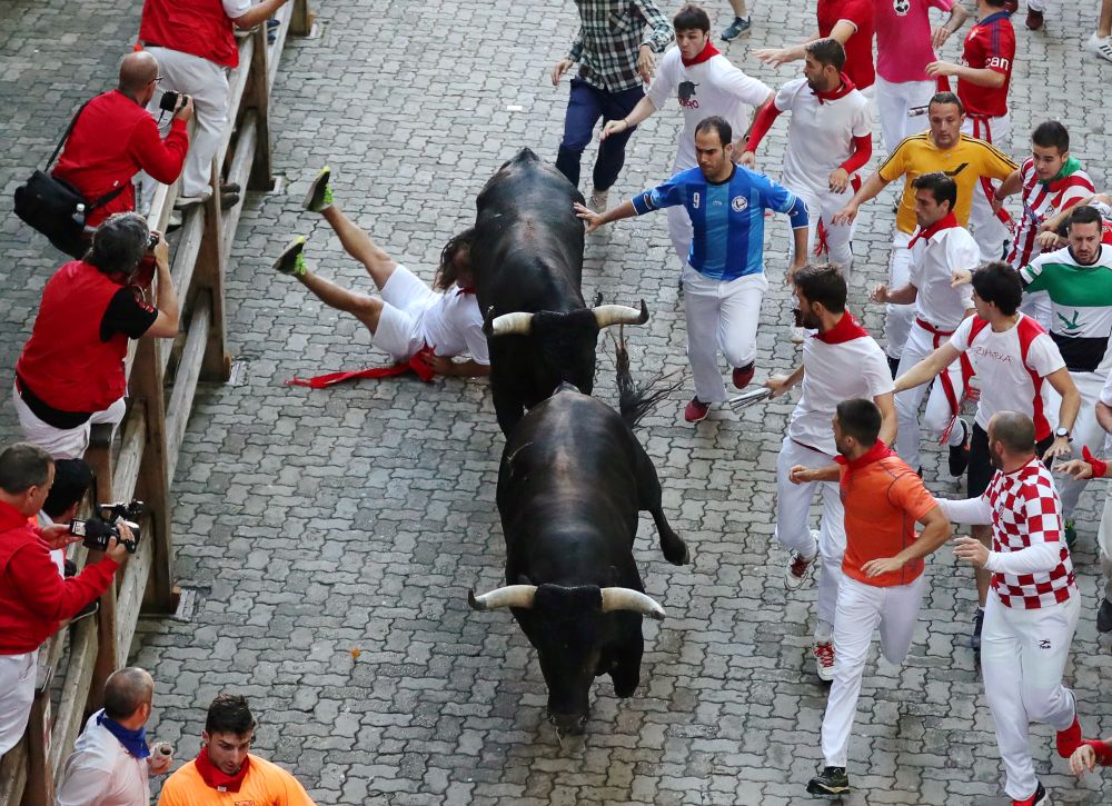 Runners sprint along the bulls during the last running of the bulls at the San Fermin festival in Pamplona, Spain, July 14, 2018. u00e2u20acu201d Reuters pic
