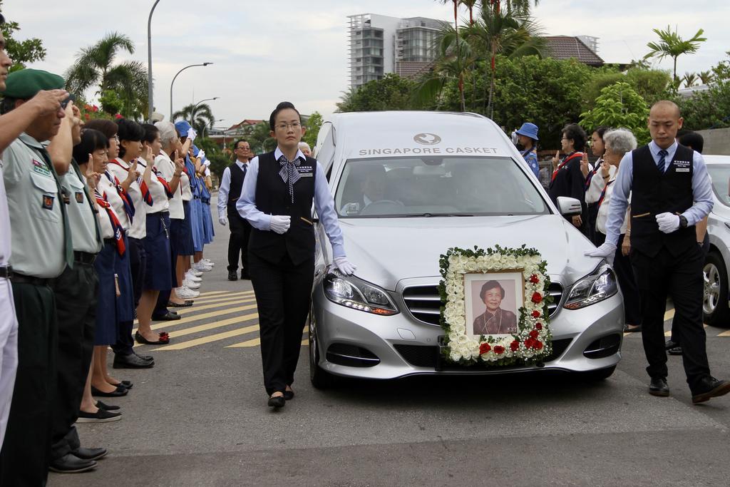 The hearse for Wee Kim Wee leaving the Wee residences, as the Scouts salute the convoy. u00e2u20acu201d Chng Shao Kai/TODAY pic