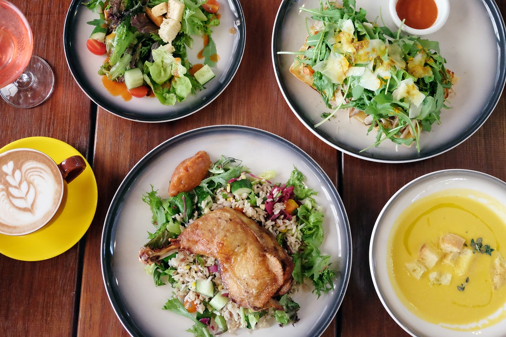 Confit chicken and warm brown rice salad (bottom), open-faced chicken focaccia (top right), salad (top left) and pumpkin soup (bottom right).  