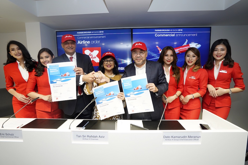 (From left) Eric Schulz, Tan Sri Rafidah Aziz and Datuk Kamarudin Meranun at the commercial announcement with Airbus at 2018 Farnborough Airshow. u00e2u20acu201d Picture courtesy of AirAsia