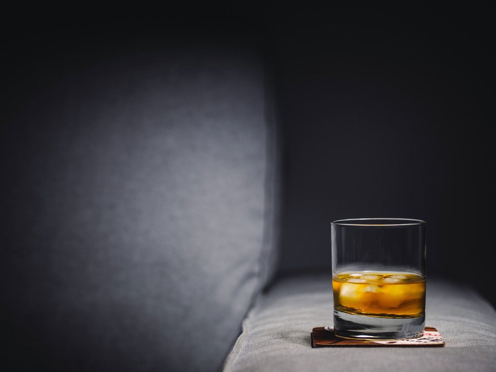 A glass of whisky awaits the drinker's appreciation. 