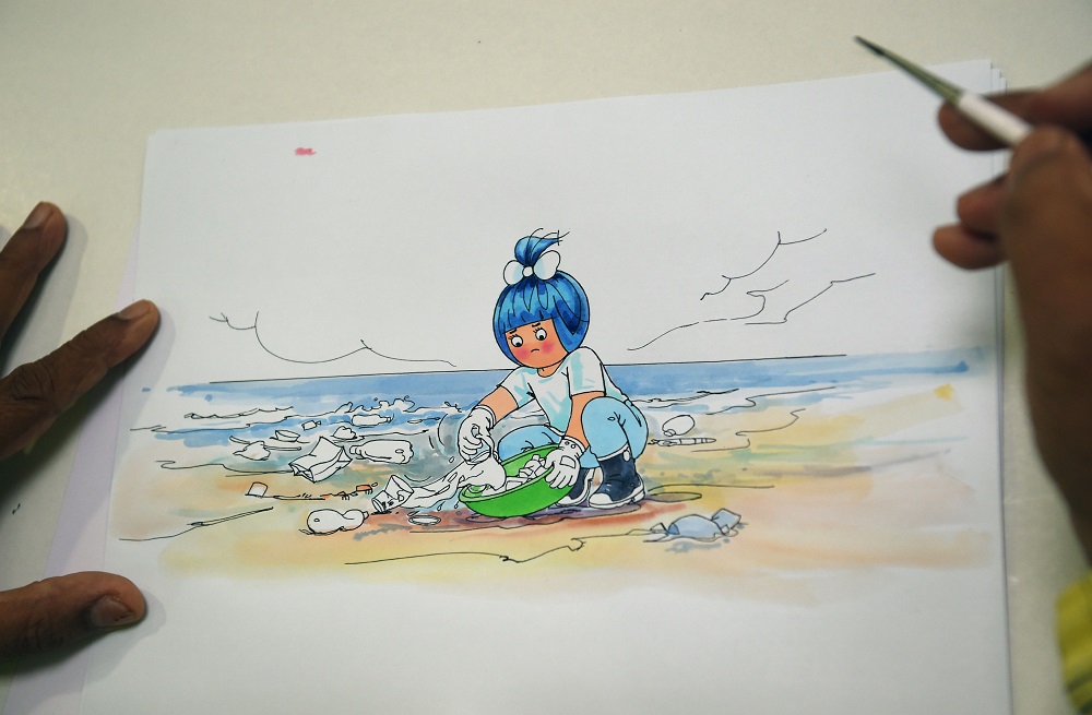 In this picture taken on May 31, 2018, Indian cartoonist Jayant Rane works on a sketch of a new Amul advertisement for World Environment Day during an interview with AFP in Mumbai. u00e2u20acu201d AFP pic