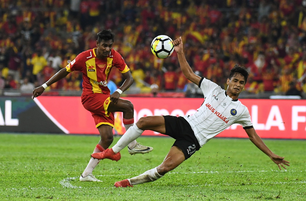Selangor player Kugan Dhevarajan (left) makes a shot at the goal during the FA Malaysia Cup finals at the National Stadium in Bukit Jalil July 7, 2018. u00e2u20acu201d Bernama pic 
