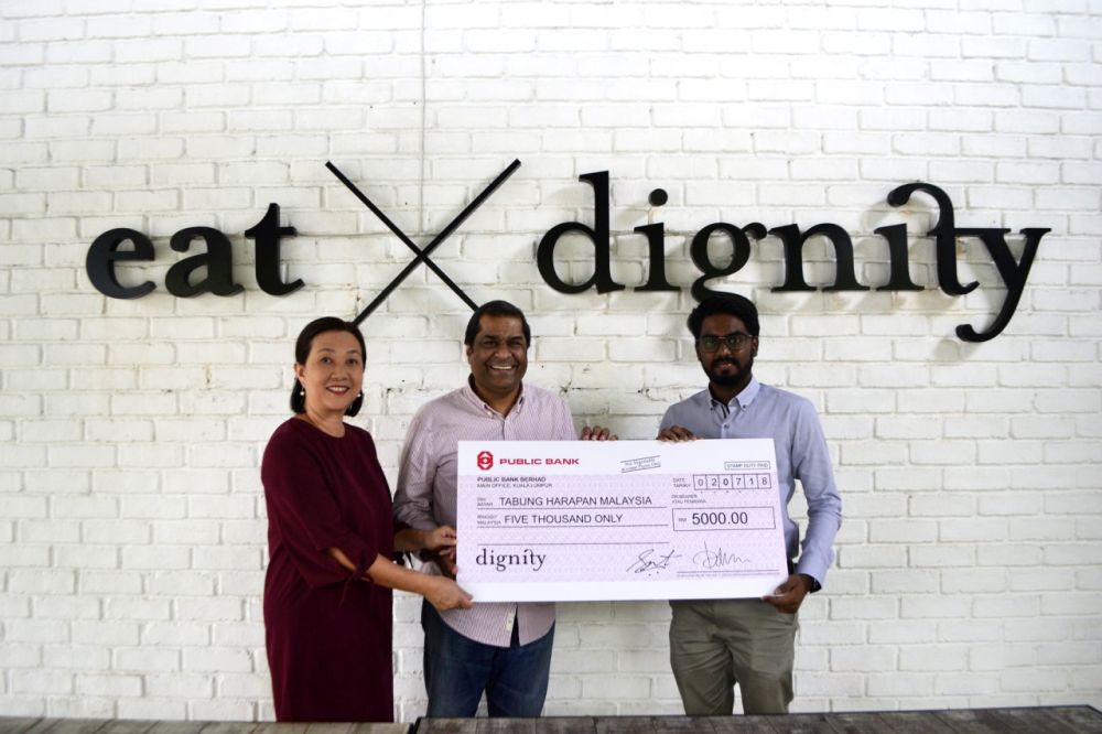 Dignity for Children Foundation’s founders Petrina Satvinder and Rev. Elisha Satvinder handing over the mock cheque to Prabakaran. ― Picture courtesy of Dignity for Children Foundation