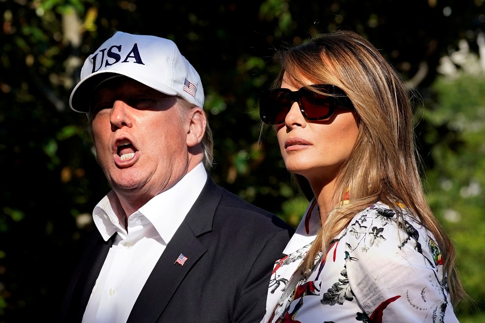 US President Donald Trump talks to reporters as he walks with first lady Melania Trump on the South Lawn of the White House upon their return from Bedminster, New Jersey, to Washington, July 8, 2018. u00e2u20acu201d Reuters pic
