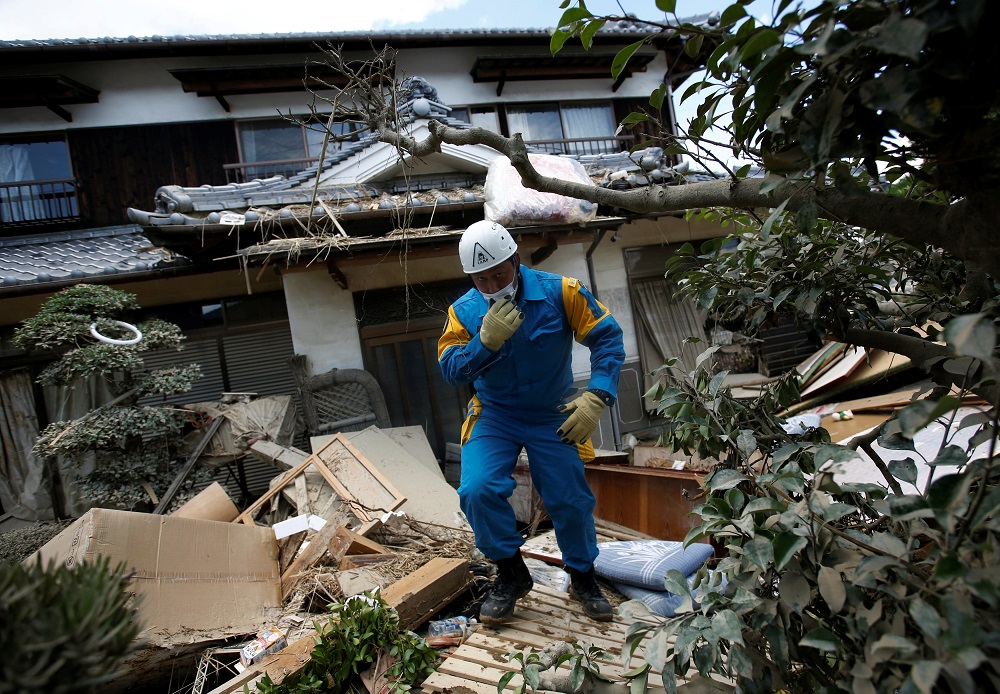 A police officer checks a submerged and destroyed house in a flood affected area in Mabi town in Kurashiki, Okayama Prefecture, Japan, July 10, 2018. u00e2u20acu201d Reuters pic
