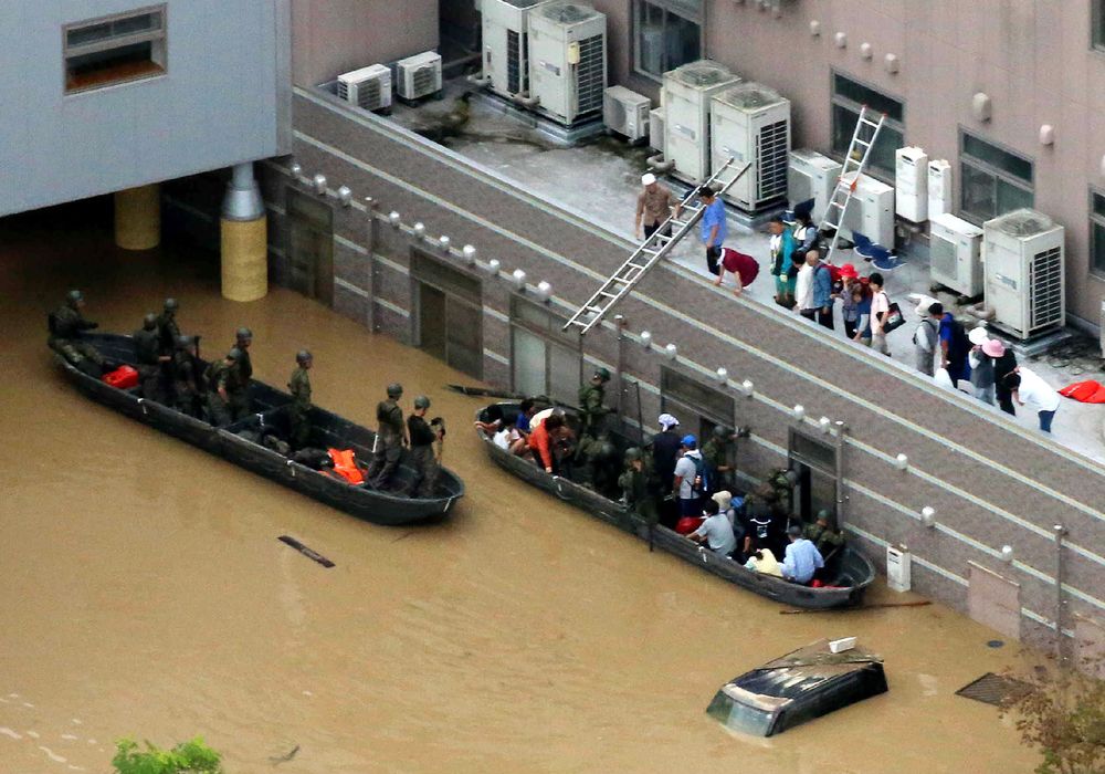 People are rescued by boats from Mabi Memorial Hospital that was isolated due to flood damage caused by heavy rain in Kurashiki, Okayama prefecture on July 8, 2018. u00e2u20acu201d- AFP pic