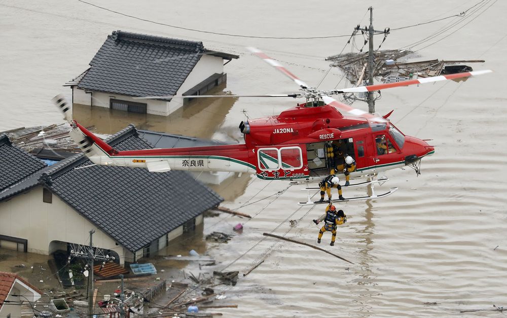 An aerial view shows a local resident being rescued from a submerged house by rescue workers using helicopter at a flooded area in Kurashiki, southern Japan, in this photo taken by Kyodo July 7, 2018. u00e2u20acu201d Kyodo/Reuters pic