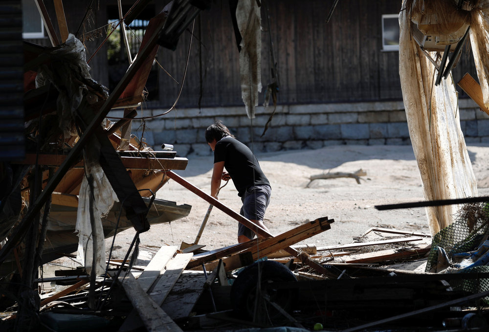 A local resident is seen near submerged and destroyed houses in a flooded area in Mabi town in Kurashiki, Okayama Prefecture July 9, 2018.  u00e2u20acu201d Reuters pic 