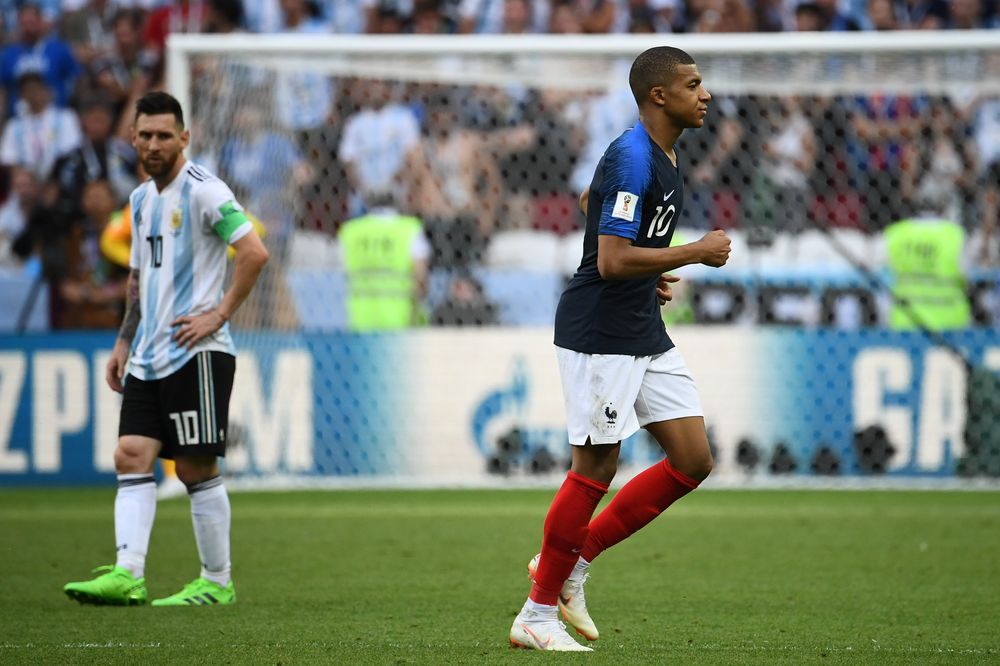 Franceu00e2u20acu2122s forward Kylian Mbappe (right) leaves the pitch as Argentinau00e2u20acu2122s Lionel Messi looks on during their World Cup round of 16 match at the Kazan Arena in Kazan on June 30, 2018. u00e2u20acu201d AFP pic