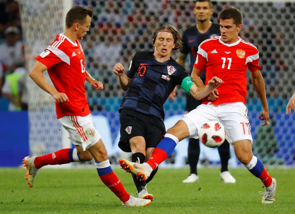 Croatiau00e2u20acu2122s Luka Modric in action with Russiau00e2u20acu2122s Roman Zobnin and Denis Cheryshev during their World Cup Quarter Final match in Fisht Stadium, Sochi, Russia, July 7, 2018. u00e2u20acu201d Reuters pic