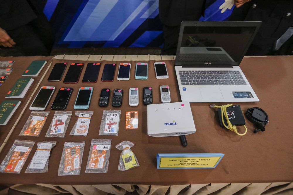 Police found 56 ATM cards, several handphones, internet routers, laptops and phones at a condominium in Kuchai Lama on July 24. — Picture by Firdaus Latif