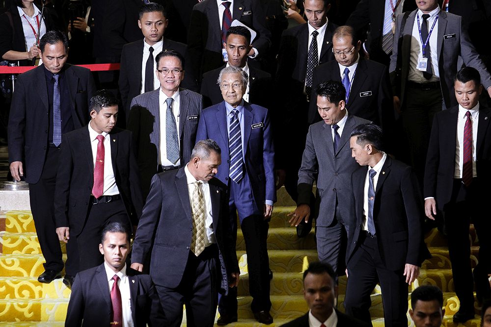 Prime Minister Tun Dr Mahathir Mohamad (centre) is pictured leaving Parliament July 23, 2018. u00e2u20acu201d Picture by Miera Zulyana