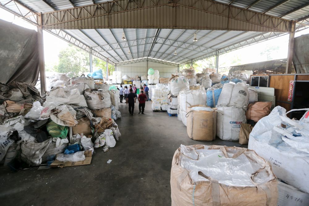 Local authorities inspect the premises of a plastic recycling plant in Jenjarom on July 24, 2018 following complaints about pollution and rising health risks to residents in Kuala Langat. u00e2u20acu201d Picture by Ahmad Zamzahuri
