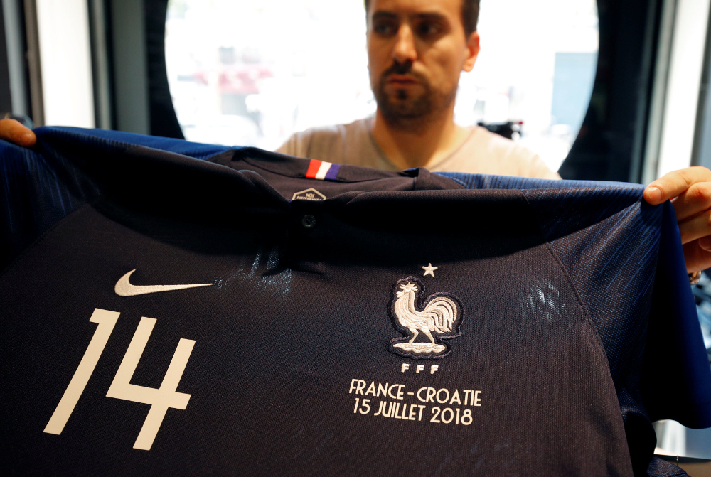 An employee displays an official France team football jersey at NSH Foot Store in Paris several days before the World Cup final, where France plays Croatia, July 12, 2018. u00e2u20acu201d Reuters pic