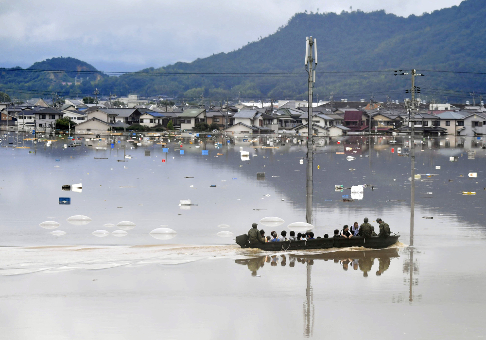 Residents are rescued from a flooded area by Japan Self-Defense Force soldiers in Kurashiki in this photo taken by Kyodo July 7, 2018. u00e2u20acu201d Picture by Kyodo via Reuters