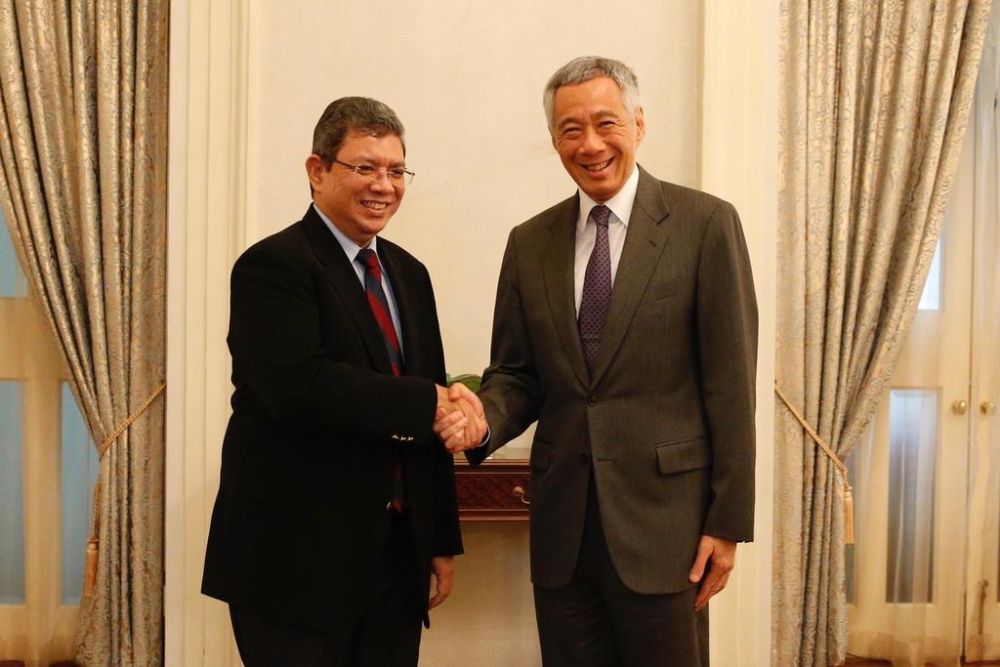 Malaysian Foreign Minister Datuk Saifuddin Abdullah shakes hands with Singapore Prime Minister Lee Hsien Loong on July 30, 2018. u00e2u20acu2022 TODAY pic