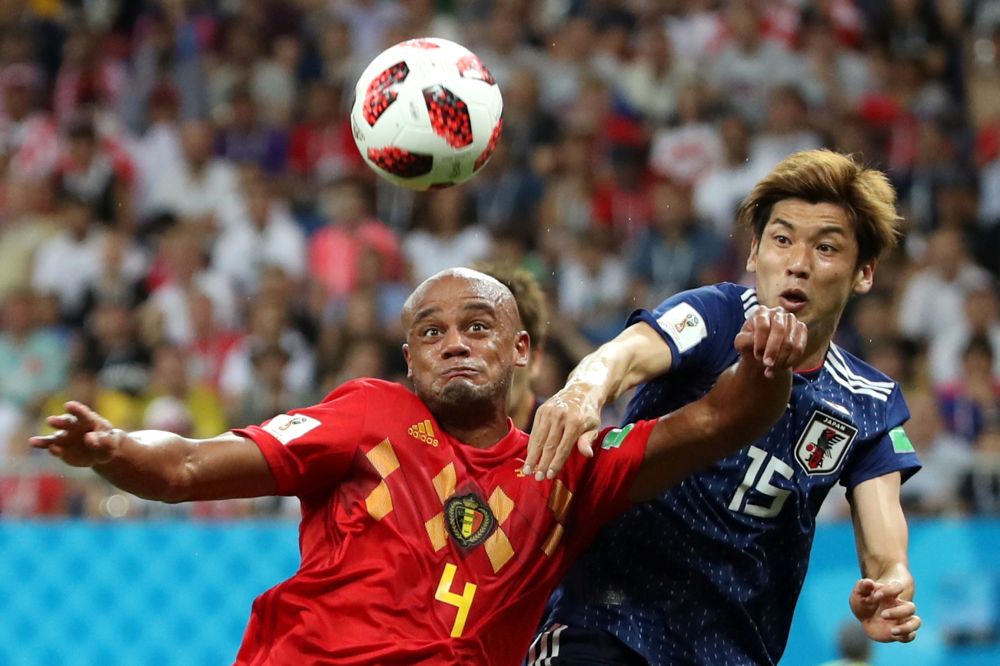 Belgium's Vincent Kompany in action with Japan's Yuya Osako, July 2, 2018. Kompany says the only way to beat Brazil is to play as a team. u00e2u20acu2022 Reuters pic