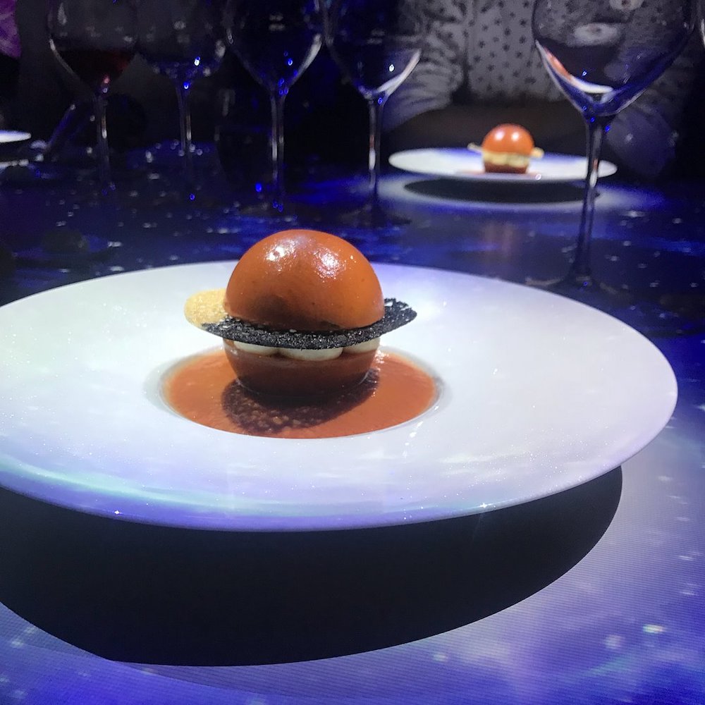 ‘The Red Planet’ is the first starter, layered Japanese momotaro tomatoes, mozzarella and basil pesto arranged into a globe that bathes in a creamy sauce.