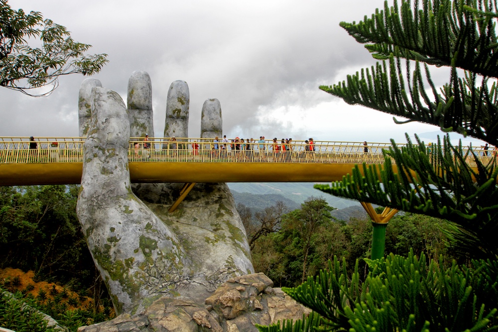 Visitors walk along the 150m-long Cau Vang u00e2u20acu02dcGolden Bridgeu00e2u20acu2122 in the Ba Na Hills near Danang July 31, 2018. u00e2u20acu201d AFP pic