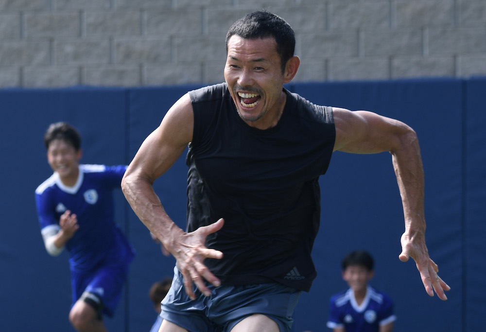 Son Woong-jung, father of South Korean football star Son Heung-min, on the pitch with his students at SON Football Academy in Chuncheon July 28, 2018. — AFP pic