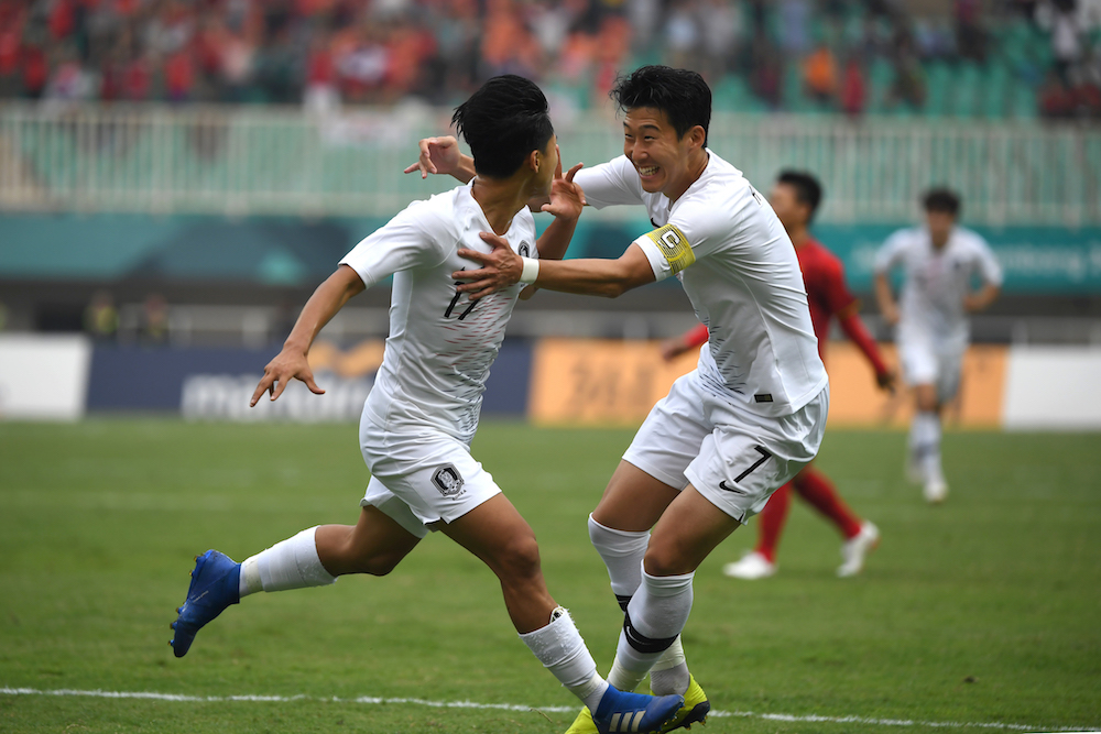 South Koreau00e2u20acu2122s Lee Seung-woo (left) celebrates with teammate Son Heung-min after scoring during the menu00e2u20acu2122s football semi-final match with Vietnam at the 2018 Asian Games in Bogor August 29, 2018. u00e2u20acu201d AFP pic