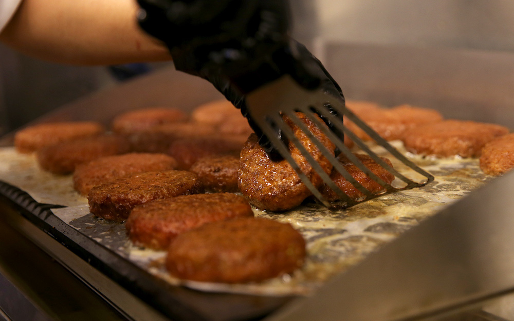 Plant-based Beyond Burger patties being prepared in restaurant mezza9’s food truck located outside the Grand Hyatt Singapore. — TODAY pic