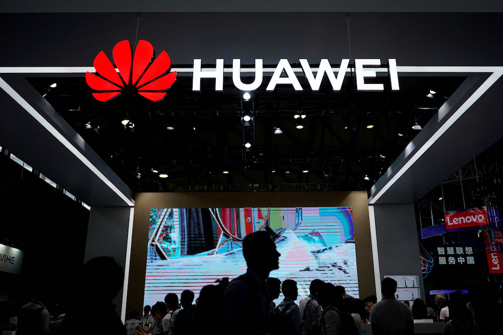 People walk past a Huawei sign at CES (Consumer Electronics Show) Asia 2018 in Shanghai June 14, 2018. u00e2u20acu201d Reuters pic