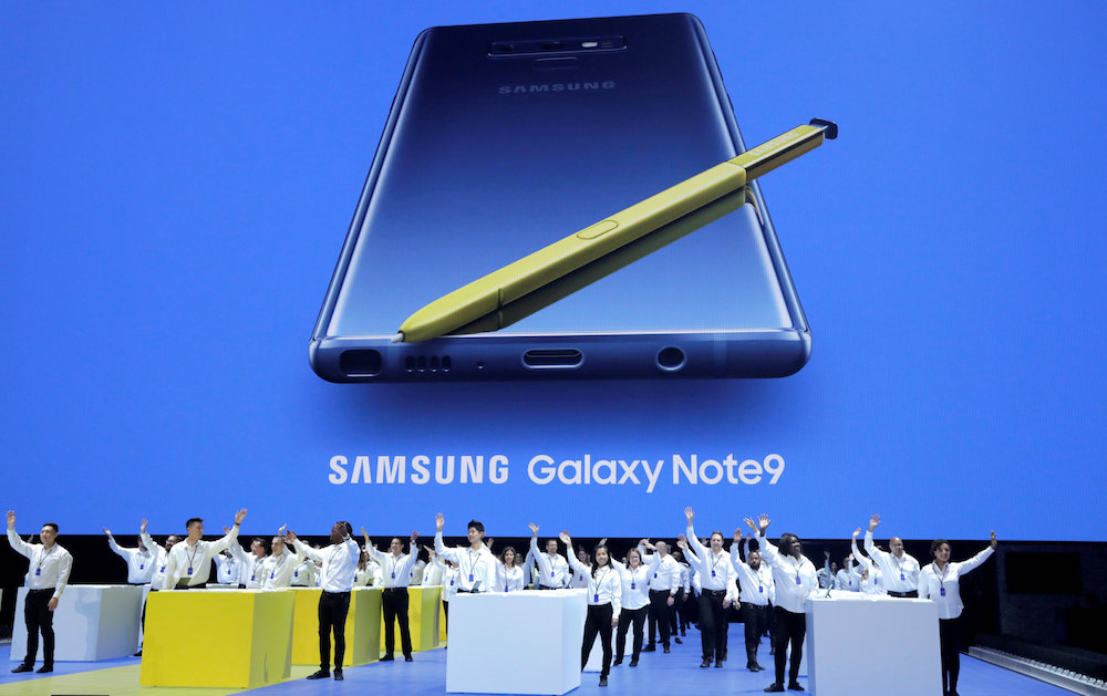Samsung employees wave from stage beneath an image of the new Samsung Galaxy Note9 during a product launch event in New York August 9, 2018. u00e2u20acu201d Reuters pic
