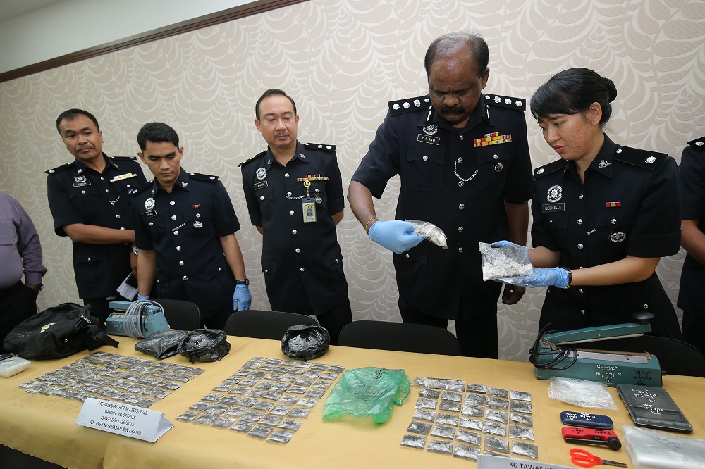 Perak Narcotics Chief Assistant Commissioner Ravi Chandran Ramachandran (fourth left) shows the confiscated items from recent drug busts during a press conference in Ipoh August 1, 2018. u00e2u20acu201d Picture by Marcus Pheong