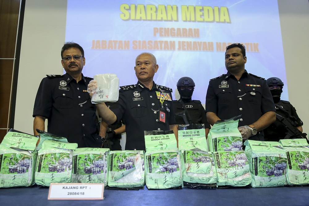 Federal Narcotics Crime Investigations Department director Commissioner Datuk Seri Mohmad Salleh (centre) shows the seized drugs during a press conference at Bukit Aman in Kuala Lumpur August 1, 2018. u00e2u20acu201d Picture by Yusof Mat Isa