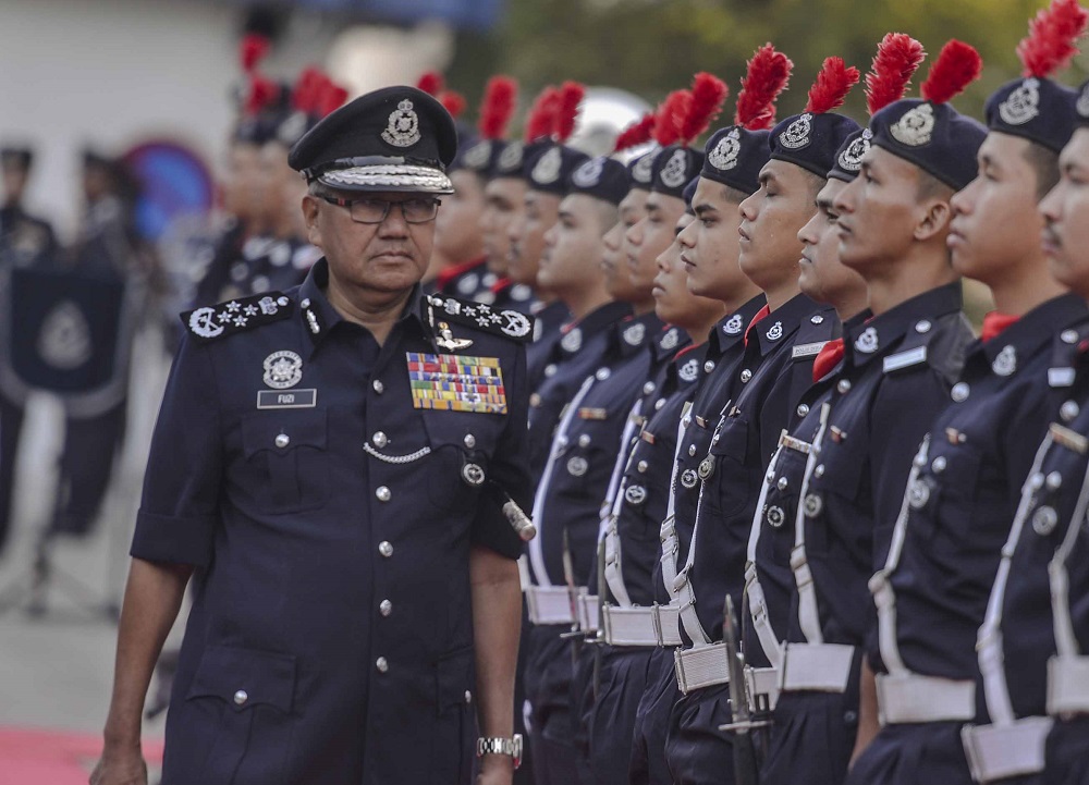 Inspector-General of Police Tan Sri Mohamad Fuzi Harun inspects the guard of honour during the monthly assembly at Bukit Aman in Kuala Lumpur August 14, 2018. u00e2u20acu201d Picture by Firdaus Latif