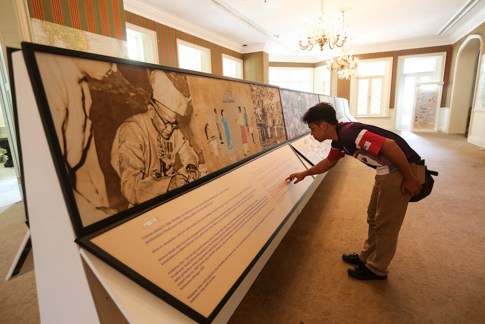 A maintenance worker conducting a routine inspection of the Jalan Merdeka exhibition display for signs of disrepair at Carcosa. — Picture by Ahmad Zamzahuri