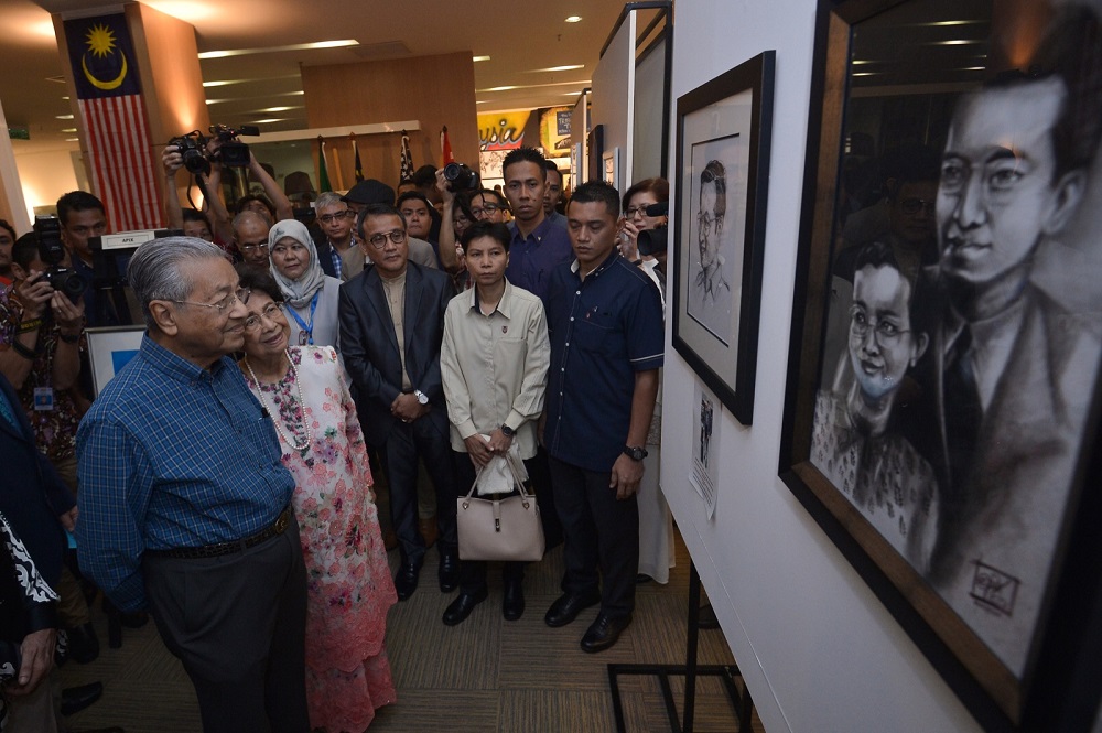 Tun Dr Mahathir Mohamad and his wife, Tun Dr Siti Hasmah, look at some of the artworks on display at the u00e2u20acu02dcTun M: A forever legacyu00e2u20acu2122 art exhibition at Perdana University in Serdang  August 12, 2018. u00e2u20acu201dPictures by Mukhriz Hazim