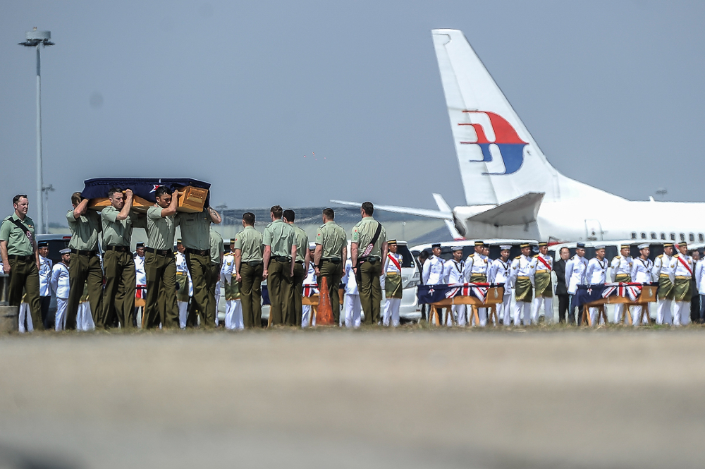 New Zealand armed forces personnel carry coffins during a ceremony to repatriate the remains of 27 New Zealand military personnel and their family at Bunga Raya complex August 20, 2018. u00e2u20acu201d Picture by Shafwan Zaidon