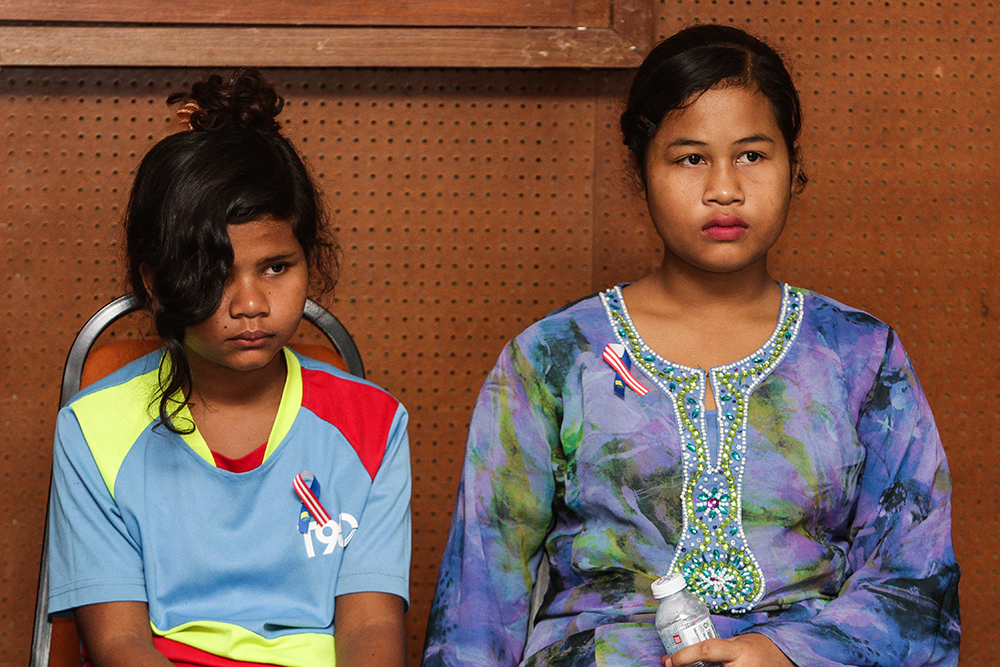 Two survivors of 2015’s Pos Tohoi tragedy, Miksudia Aluj, 13 (left), and Norieen Yakob, 14, attend a press conference in Kuala Lumpur August 24, 2018. — Picture by Miera Zulyana