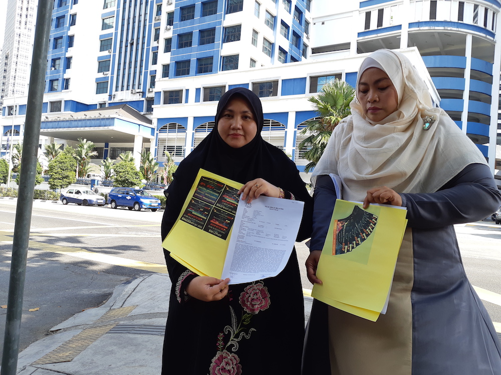 Gerakan Muslimah Islam Malaysia (GMIM) president Wan Asshima Kamaruddin shows reporters the purported advertisement for ticket sales for a purported three-night gay festival in Kuala Lumpur to be held from August 30 to September 1. u00e2u20acu201d Picture by Ida Lim