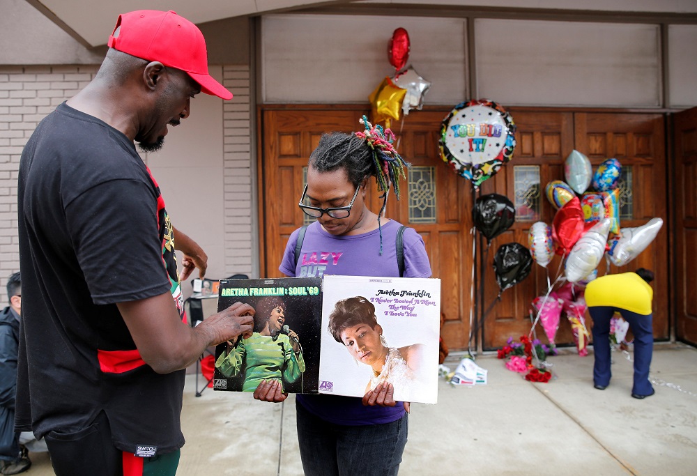 Mourners Terry Tarrant and Shantray look at album covers, in memory of singer Aretha Franklin, outside the New Bethel Baptist church in Detroit, Michigan, August 16, 2018. u00e2u20acu201d Reuters pic